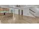 Open concept living area includes kitchen island, staircase, and access to outdoor area at 3100 Greenville Loop Rd, Wake Forest, NC 27587