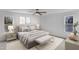 Serene bedroom with neutral colors, a cushioned bench, and natural light from two windows at 3100 Greenville Loop Rd, Wake Forest, NC 27587