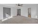 Main bedroom featuring ceiling fan, multiple closets, neutral carpet, and en suite bathroom at 3100 Greenville Loop Rd, Wake Forest, NC 27587