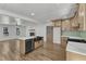 Open floorplan showcases kitchen with island open to living area with fireplace at 3100 Greenville Loop Rd, Wake Forest, NC 27587