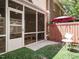 Backyard with a screened-in porch, red umbrella, patio furniture, and a well-maintained lawn at 3125 Morningside Dr, Raleigh, NC 27607