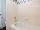 Bathroom featuring blue and white tiles, a gold shower head, and white tub at 3125 Morningside Dr, Raleigh, NC 27607