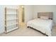 Neutral bedroom featuring a shelf and comfortable bed with a cushioned headboard at 3125 Morningside Dr, Raleigh, NC 27607