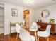 Cozy dining area with hardwood floors, modern chairs, and a view into the kitchen at 3125 Morningside Dr, Raleigh, NC 27607