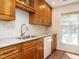 Well-lit kitchen features wooden cabinets, white marble backsplash, and a stainless steel sink at 3125 Morningside Dr, Raleigh, NC 27607
