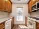 Spacious kitchen featuring wooden cabinets, white appliances, countertops, and a window at 3125 Morningside Dr, Raleigh, NC 27607