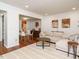 Spacious living room featuring a comfortable sectional sofa, hardwood floors, and dining area at 3125 Morningside Dr, Raleigh, NC 27607
