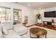 Bright living room featuring a large sectional sofa, area rug, hardwood floors, and natural light at 3125 Morningside Dr, Raleigh, NC 27607