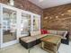 An inviting patio with brick walls, comfortable seating, string lights, and an access door at 3125 Morningside Dr, Raleigh, NC 27607