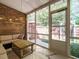 The screened porch has brick walls, string lights and view of the back yard at 3125 Morningside Dr, Raleigh, NC 27607