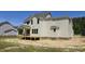 View of the back exterior with a deck overlooking a spacious yard and lush greenery at 317 Hampshire Court, Four Oaks, NC 27524