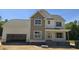Charming two-story home featuring a classic design, attached garage, and inviting front porch at 317 Hampshire Court, Four Oaks, NC 27524