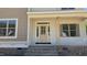Inviting front porch featuring a classic front door and brick stairs, and shuttered windows at 317 Hampshire Court, Four Oaks, NC 27524