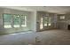 Bright and airy living room under construction, featuring large windows and a doorway at 317 Hampshire Court, Four Oaks, NC 27524