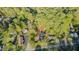 An aerial view shows this property situated within a lush, wooded lot with a long private drive and ample surrounding greenery at 322 W Hill N Ave, Hillsborough, NC 27278