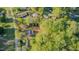 An aerial view shows this property situated within a lush, wooded lot with a long private drive and ample surrounding greenery at 322 W Hill N Ave, Hillsborough, NC 27278