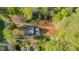 Aerial view of the property showcasing the house, yard, sheds, and surrounding trees offering privacy and tranquility at 322 W Hill N Ave, Hillsborough, NC 27278