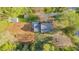 Aerial view of charming home with large backyard and ample privacy with gravel parking and mature trees around the perimeter at 322 W Hill N Ave, Hillsborough, NC 27278