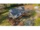 Aerial view of charming home with landscaped grounds, brick walkway, and private gravel parking in serene residential neighborhood at 322 W Hill N Ave, Hillsborough, NC 27278