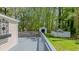 Spacious gray back deck with seating area, perfect for enjoying outdoor living and the yard at 322 W Hill N Ave, Hillsborough, NC 27278