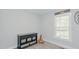 Bright bedroom featuring wood-look floors, a window, and a dresser at 322 W Hill N Ave, Hillsborough, NC 27278