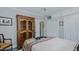 Spacious bedroom featuring hardwood style floors, an armoire, and large window at 322 W Hill N Ave, Hillsborough, NC 27278