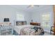 Bright bedroom with gray walls, side table, and traditional wooden dresser at 322 W Hill N Ave, Hillsborough, NC 27278