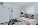 Bedroom with soft gray walls, a window, and built in closets at 322 W Hill N Ave, Hillsborough, NC 27278