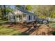 Charming exterior of this home with well maintained lawn, brick walkway, tasteful landscaping and a private parking area at 322 W Hill N Ave, Hillsborough, NC 27278