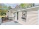 Charming exterior featuring a lovely back porch, decorative ironwork, and light-colored siding, creating a welcoming ambiance at 322 W Hill N Ave, Hillsborough, NC 27278