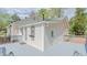Low angle of home featuring gray deck, light siding, and decorative iron accent at 322 W Hill N Ave, Hillsborough, NC 27278
