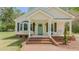 Charming home featuring a welcoming front porch with a bright, light-blue front door at 322 W Hill N Ave, Hillsborough, NC 27278