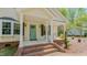 Inviting front porch with a brick walkway and classic architectural details at 322 W Hill N Ave, Hillsborough, NC 27278
