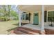 Front porch showcasing a blue front door, brick steps, white columns, and a bay window with black shutters at 322 W Hill N Ave, Hillsborough, NC 27278