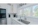 Bright kitchen showcasing a large window, stainless steel appliances, and white cabinets for an inviting atmosphere at 322 W Hill N Ave, Hillsborough, NC 27278