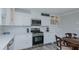 Well-appointed kitchen with white cabinets, modern appliances, and stylish details for a delightful cooking experience at 322 W Hill N Ave, Hillsborough, NC 27278