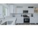 Beautiful kitchen features white cabinets, stainless steel appliances, and modern design elements for cooking convenience at 322 W Hill N Ave, Hillsborough, NC 27278