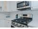 A modern and efficient kitchen space featuring stainless steel appliances and white cabinets for contemporary living at 322 W Hill N Ave, Hillsborough, NC 27278
