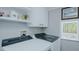 Practical laundry room with modern appliances and ample shelving for storage at 322 W Hill N Ave, Hillsborough, NC 27278