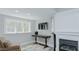 Living Room featuring fireplace, TV, and lots of natural light at 322 W Hill N Ave, Hillsborough, NC 27278