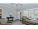 Comfortable seating in living room with bay window and light hardwood style floors at 322 W Hill N Ave, Hillsborough, NC 27278