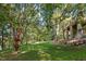 The home sits on a large, beautifully landscaped lot with mature trees and lush grass, creating a serene outdoor space at 32430 Archdale, Chapel Hill, NC 27517