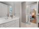 Bright bathroom with white cabinets, a large mirror, and access to the bedroom at 32430 Archdale, Chapel Hill, NC 27517