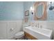 Charming powder room with patterned wallpaper, decorative mirror, and a stylish sink at 32430 Archdale, Chapel Hill, NC 27517