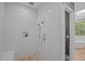 Tiled walk-in shower with modern fixtures, a built-in bench, and neutral tones at 32430 Archdale, Chapel Hill, NC 27517