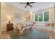 Sunlit bedroom featuring a ceiling fan, window seat, and queen-sized bed at 32430 Archdale, Chapel Hill, NC 27517