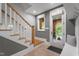 Inviting foyer features a staircase and a door that opens to an outdoor stone patio, creating a seamless transition at 32430 Archdale, Chapel Hill, NC 27517