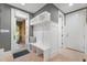 Charming foyer with a built-in bench and coat rack offers a cozy welcome with outside views to the stone patio at 32430 Archdale, Chapel Hill, NC 27517