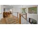 Bright hallway with wood floors, white railings, and views to the outside at 32430 Archdale, Chapel Hill, NC 27517