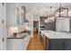 Spacious kitchen featuring white cabinetry, a large island with marble countertops, and stainless steel appliances at 32430 Archdale, Chapel Hill, NC 27517